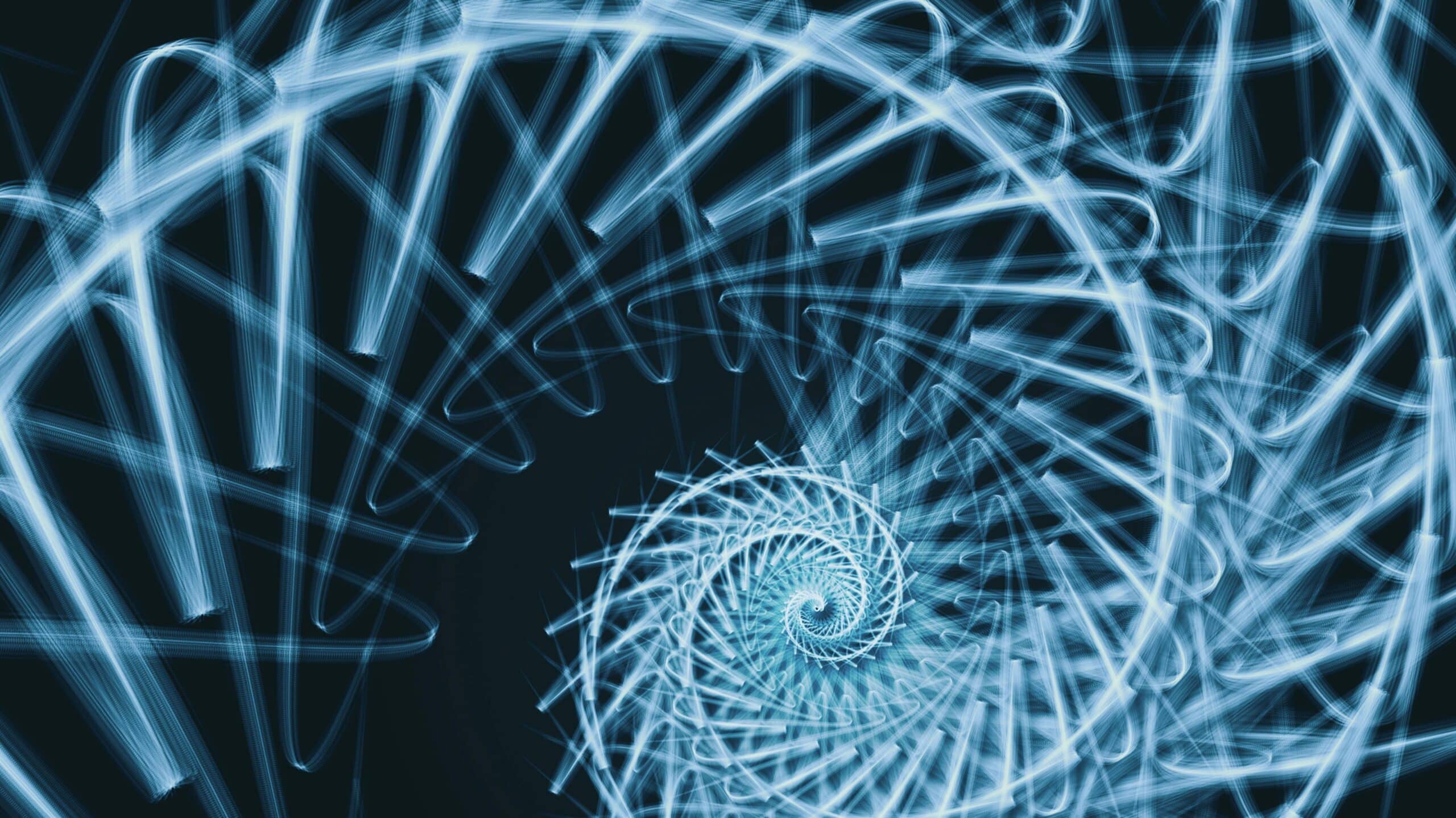 Blue glowing fractal spiral shell pattern made of curved light streaks on dark background