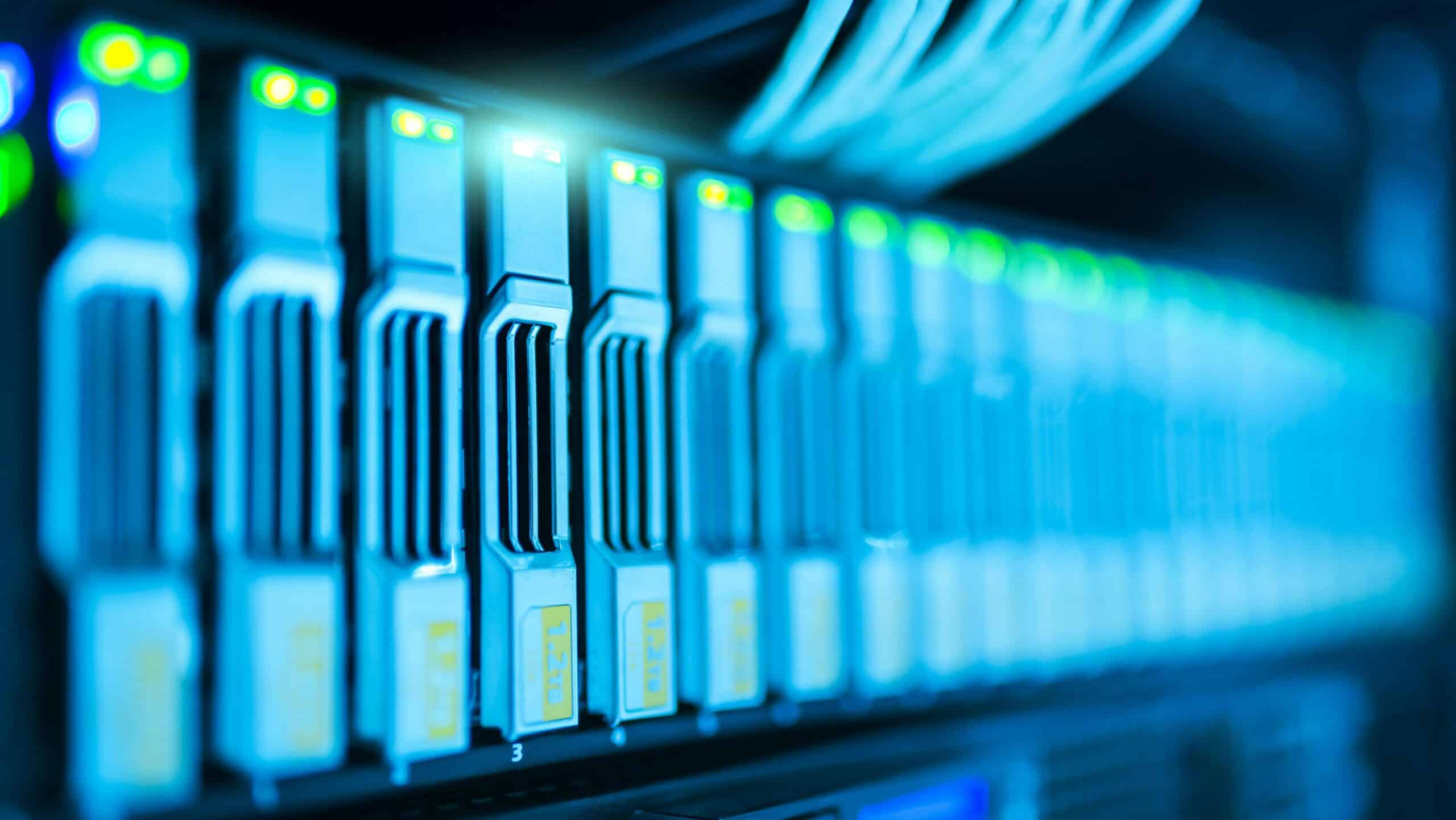 Long corridor of blue-lit server racks in a data center