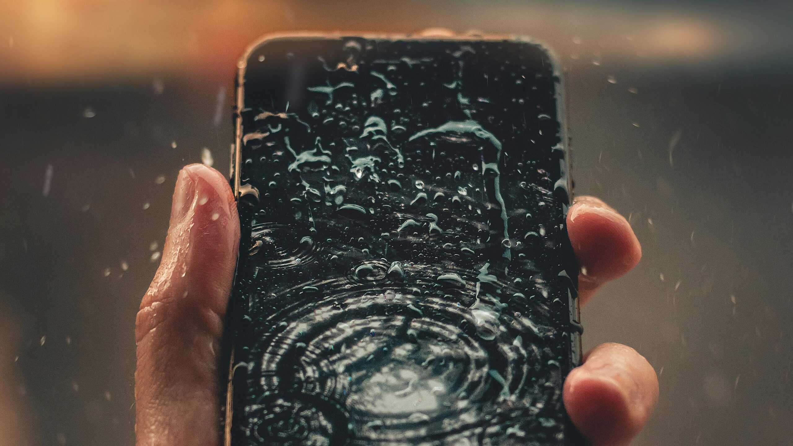 Hand holding a smartphone displaying a dark swirling digital morphing effect on screen